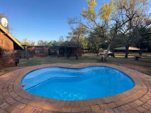 a small blue pool in a brick patio at Bush Lovers Lodge in Modimolle