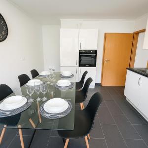 a dining room with a table with plates and wine glasses at Koblenz Exclusive Residence in Koblenz