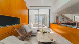 a living room with a couch and a table at Villa AMAYA Grand Luxe face a la mer in Douar el Hafey