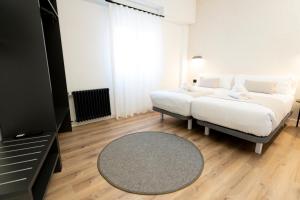 une chambre avec un lit et une télévision à écran plat dans l'établissement TeruelHOME GOLD, à Teruel