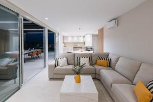 a living room with a couch and a table at Salobre Homes in Salobre