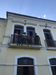 a group of people on a balcony of a building at Fazenda Neuchatel in Guaratinguetá
