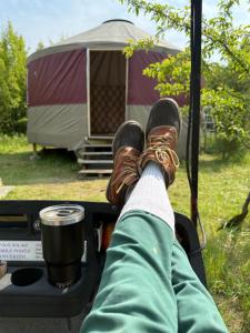 a person with their feet in the back of a truck with a tent at Fazenda Neuchatel in Guaratinguetá