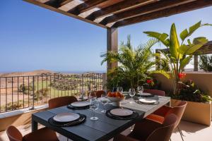 a dining room with a table and chairs at Kaiman Suites in Salobre