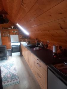 a kitchen with a counter top and a stove at Le chalet a la ferme in Massat