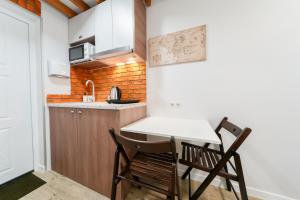 a small kitchen with a table and two chairs at Апартаменти MYFREEDOM поруч інститут Шалімова in Kyiv