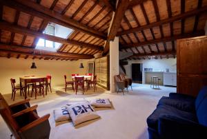 a living room with a couch and a table and chairs at Appartamento Rebel House in Pergola