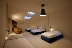 a bedroom with two beds and a skylight at Appartamento Rebel House in Pergola