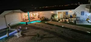 an aerial view of a backyard at night at Dar Dalloula maison de vacances espace detente in Shanīnī