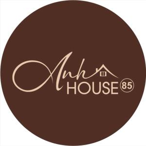 a logo for a mill house in a brown circle at Anh House 85 in Da Nang