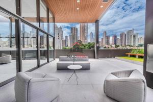 a living room with a view of a city at Lumen in Sao Paulo
