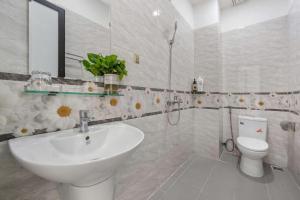 a bathroom with a sink and a toilet at Anh House 85 in Da Nang