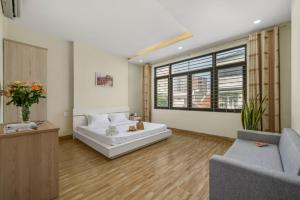 a living room with a bed and a couch at Anh House 85 in Da Nang