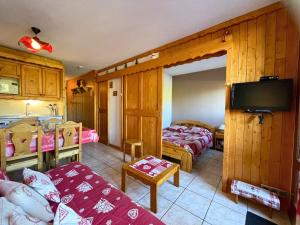 ein Wohnzimmer mit 2 Betten und eine Küche in der Unterkunft Grand studio pour 4, Les Menuires, aux pieds des pistes - FR-1-452-397 in Les Menuires