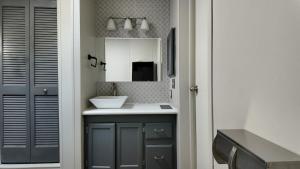 a bathroom with a sink and a mirror at Faith short term rental in Romulus +47 photos