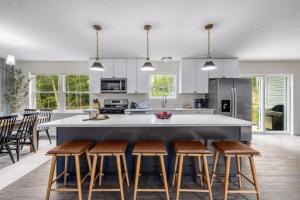 a kitchen with a large island with bar stools at Best Deal In The Poconos! in Pocono Country Place