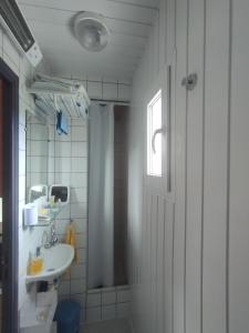 a bathroom with a sink and a toilet and a window at La Petite Maison dans la Vigne in Gaujac