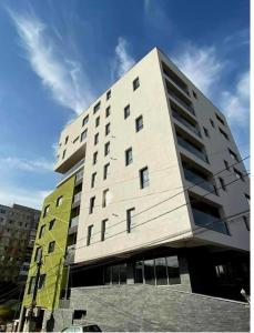 a large white building in a city at Central Luxury Apartament in Tulcea