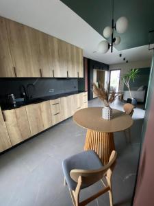 a kitchen with a table and a dining room at Aura dom na wynajem in Jeziorki +9 photos