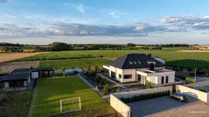 an aerial view of a house with a soccer field at Aura dom na wynajem in Jeziorki