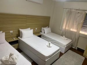 a small room with two beds and a window at Cairo downtown apartment studio in Cairo