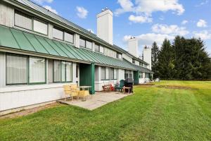 un edificio con sillas y mesas en el patio en Village Green 9F, en Stowe