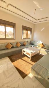 a living room with a couch and a coffee table at Dakhla sky blue in Dakhla