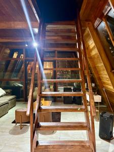 a set of wooden stairs in a room at Chalé da Serra in Araruna +24 photos
