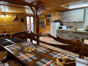 a kitchen with a wooden table in a cabin at Pid Playem in Volovets