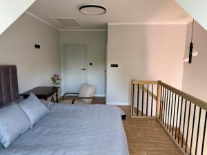 a bedroom with a bed and a staircase with a table at Dom w centrum Tucholi in Tuchola