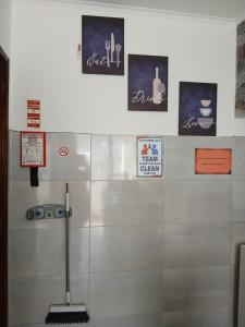a bathroom with signs on the wall of a stall at Macarena-AL in Almada