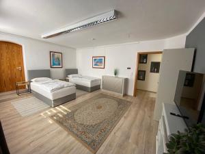a living room with a bed and a couch at Apartment Q im Zentrum von Königsbronn in Königsbronn
