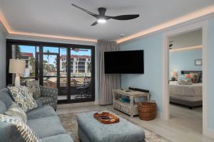 a living room with a couch and a flat screen tv at Pointe Santo E3 - Gorgeous Corner Residence at Pointe Santo in Ybel