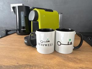 ビーレフェルトにあるModern studio for 2 - Central I Parking I WiFiの白いコーヒーマグカップ2つ