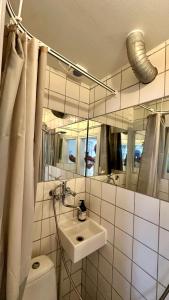 a bathroom with a sink and a toilet and a mirror at The Latin quarter in Copenhagen