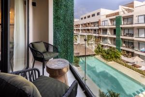 a balcony of a hotel with a swimming pool at Bakal Studios in Tulum +23 photos