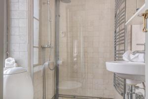 a bathroom with a shower and a sink at Historic apartment in Old Town in Stockholm