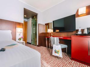 a hotel room with a bed and a desk at Mercure Roma Piazza Bologna in Rome +110 photos