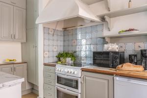 a kitchen with a stove and a microwave at Historic apartment in Old Town in Stockholm