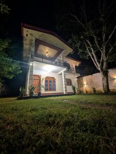a house at night with the lights on at Sea Breeze Rest in Talalla