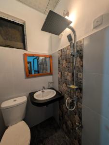 a bathroom with a toilet and a sink at Sea Breeze Rest in Talalla South +35 photos
