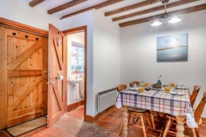 a dining room with a table and chairs at China Cottage in Weybourne