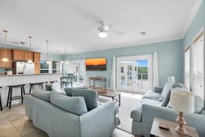 a living room with two couches and a kitchen at Navigate Stays Private Home with Pool Hot-Tub & Dock in Crawl Key Number Two +31 photos