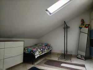 a attic bedroom with a bed and a skylight at Casa Raffaele in Borgaro Torinese