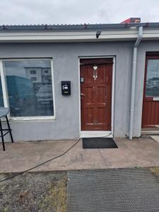 a building with a brown door and a window at Hafnargata 44 Keflavík 230 in Keflavík