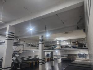 a large room with a staircase in a building at Shri laddu Gopal dham in Chhatikara