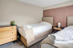 a bedroom with two beds and a dresser at Station House in Redcar +17 photos