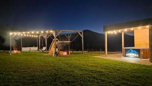 a tent with lights in a field at night at Zacisze w Karkonoszach in Karpacz +29 photos