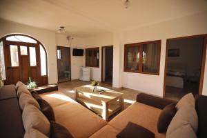 a living room with a couch and a table at Casa Selina in Corbu