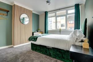 a bedroom with a large bed and a window at Station House in Redcar
